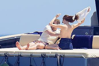 Phoebe Dynevor in bikini and topless on a yacht in St. Tropez