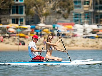 Rachel McCord in a bikini paddle boarding in Marina del Rey