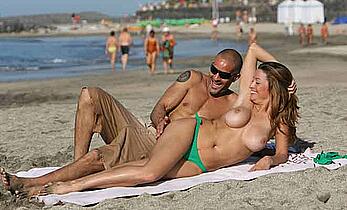 Rebecca Loos topless on a beach with honey