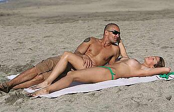 Rebecca Loos topless on a beach with honey