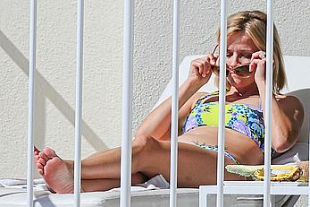 Reese Witherspoon in bikini on balcony of the Turtle Bay Resort in Oahu