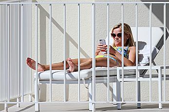 Reese Witherspoon in bikini on balcony of the Turtle Bay Resort in Oahu