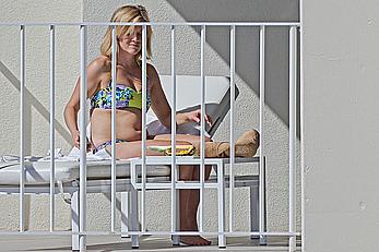 Reese Witherspoon in bikini on balcony of the Turtle Bay Resort in Oahu