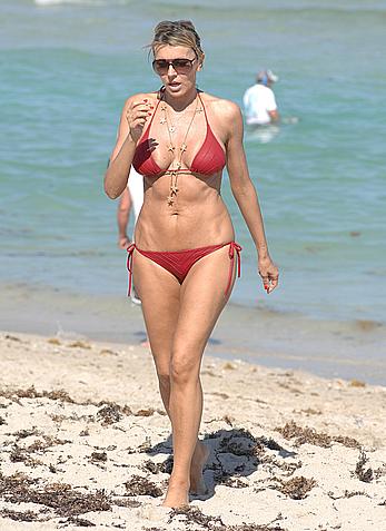 Rita Rusic in red bikini at a beach