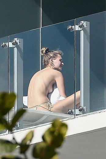 Roosmarijn de Kok sunbathing topless on her balcony in Miami