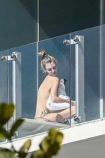 Roosmarijn de Kok sunbathing topless on her balcony in Miami