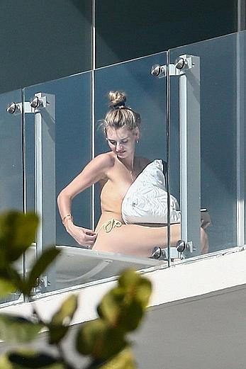 Roosmarijn de Kok sunbathing topless on her balcony in Miami