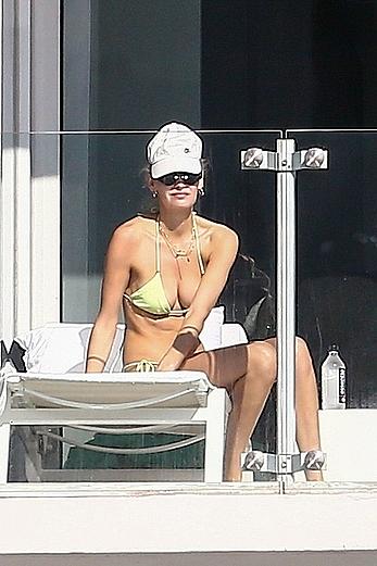 Roosmarijn de Kok sunbathing topless on her balcony in Miami