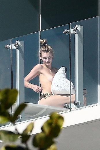 Roosmarijn de Kok sunbathing topless on her balcony in Miami