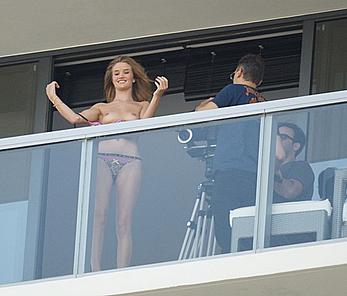 Rosie Huntington-Whiteley topless on a balcony during photoshoot