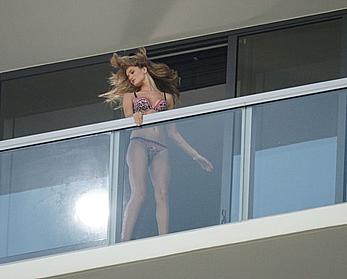 Rosie Huntington-Whiteley topless on a balcony during photoshoot