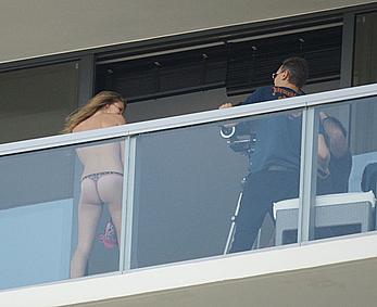 Rosie Huntington-Whiteley topless on a balcony during photoshoot