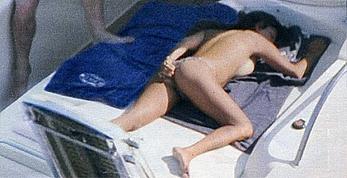 Busty Sabrina Ferilli sunbathing topless on a yacht