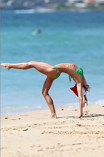 Sharni Vinson in green bikini aerobics on the beach in Sydney