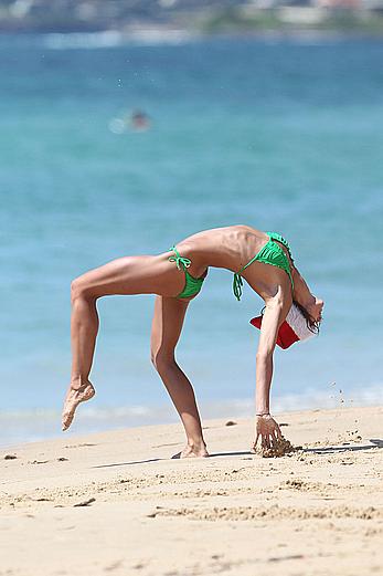 Sharni Vinson in green bikini aerobics on the beach in Sydney