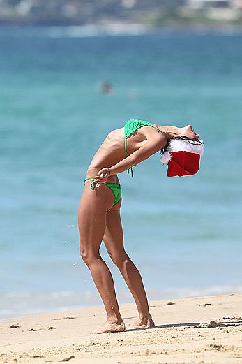 Sharni Vinson in green bikini aerobics on the beach in Sydney