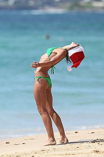 Sharni Vinson in green bikini aerobics on the beach in Sydney