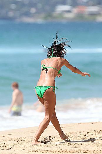 Sharni Vinson in green bikini aerobics on the beach in Sydney