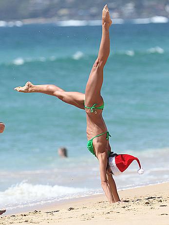 Sharni Vinson in green bikini aerobics on the beach in Sydney