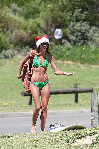 Sharni Vinson in green bikini aerobics on the beach in Sydney