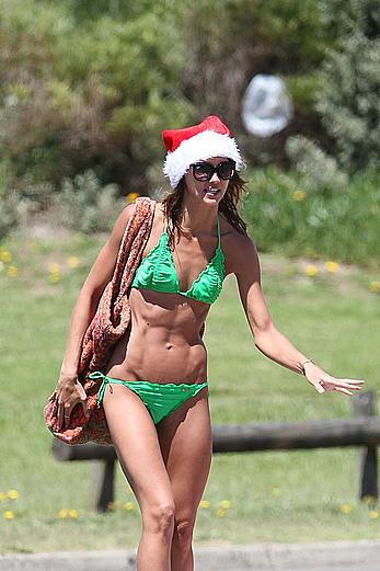 Sharni Vinson in green bikini aerobics on the beach in Sydney