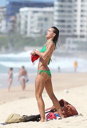 Sharni Vinson in green bikini aerobics on the beach in Sydney