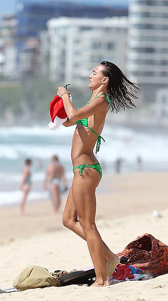 Sharni Vinson in green bikini aerobics on the beach in Sydney