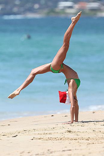 Sharni Vinson in green bikini aerobics on the beach in Sydney