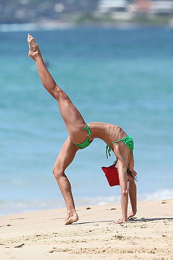 Sharni Vinson in green bikini aerobics on the beach in Sydney