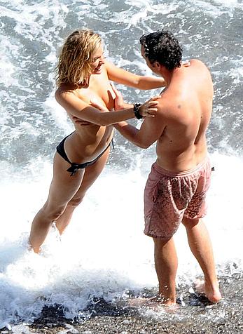 Sienna Miller caught topless on a beach