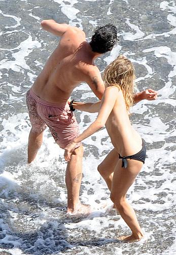 Sienna Miller caught topless on a beach