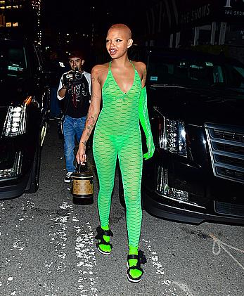 Slick Woods braless in lime green see through one-piece following Rihanna’s Fenty after party in New York