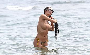 Busty Soraja Vucelic goes topless to show her boobs at a beach