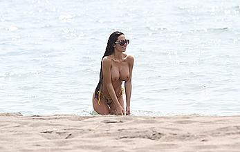 Busty Soraja Vucelic goes topless to show her boobs at a beach