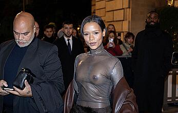 Taylor Russell braless in a see through top leaving her hotel in Paris