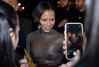 Taylor Russell braless in a see through top leaving her hotel in Paris