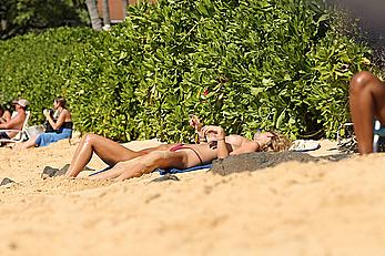 Toni Garrn sunbathing topless on a beach in Hawaii