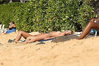 Toni Garrn sunbathing topless on a beach in Hawaii