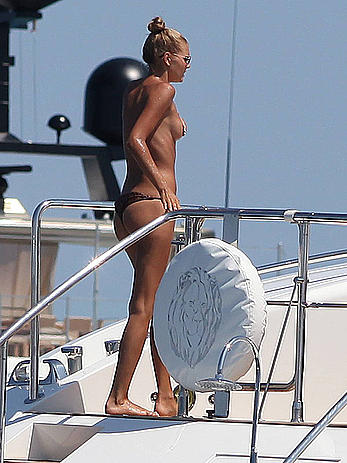 Toni Garrn in bikini and topless on a yacht in Ibiza