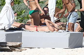 Toni Garrn sunbathing topless on the beach in Miami