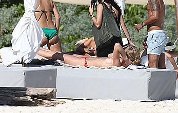 Toni Garrn sunbathing topless on the beach in Miami