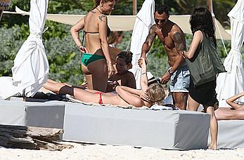 Toni Garrn sunbathing topless on the beach in Miami