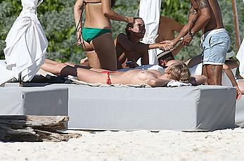 Toni Garrn sunbathing topless on the beach in Miami