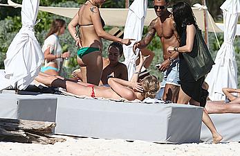 Toni Garrn sunbathing topless on the beach in Miami