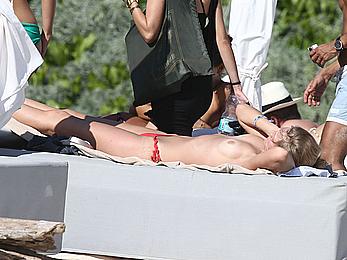 Toni Garrn sunbathing topless on the beach in Miami