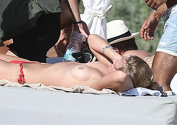 Toni Garrn sunbathing topless on the beach in Miami