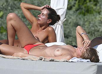 Toni Garrn sunbathing topless on the beach in Miami