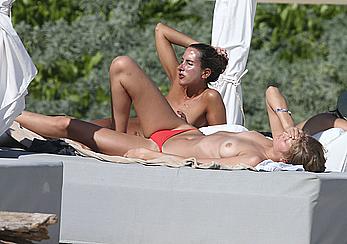 Toni Garrn sunbathing topless on the beach in Miami