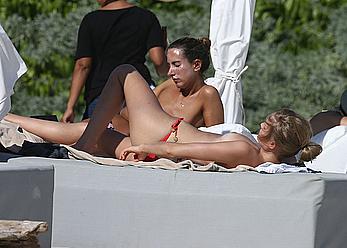 Toni Garrn sunbathing topless on the beach in Miami