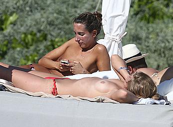 Toni Garrn sunbathing topless on the beach in Miami